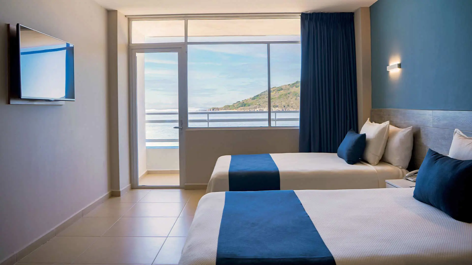 Room with two double beds and ocean view at Hotel Star Palace Mazatlán